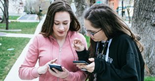 Two young with their cellphones